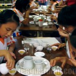 School children learning to make tea