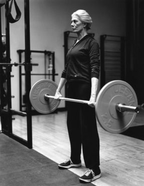 A matured woman doing weight-lifting