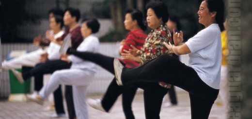 A group playing a taichi dance in the corner of a small park, Ch