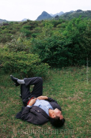 Driver sleeping on grass