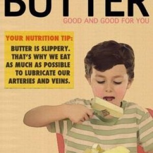 A small boy forking an inch thick slab of butter to bite