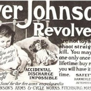 Small girl with revolver in bed