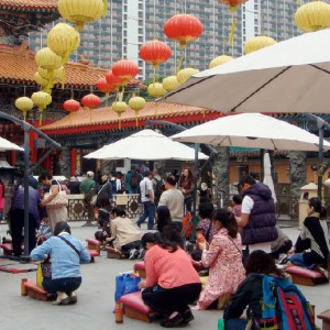 People praying for flavours from a deity in a Daoist temple in H