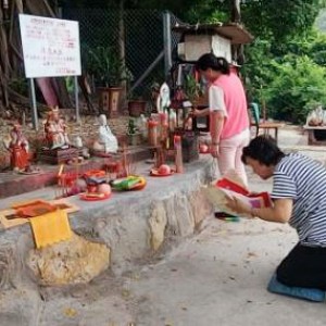 Worshipping of a folk diety on a side street in Hong Kong