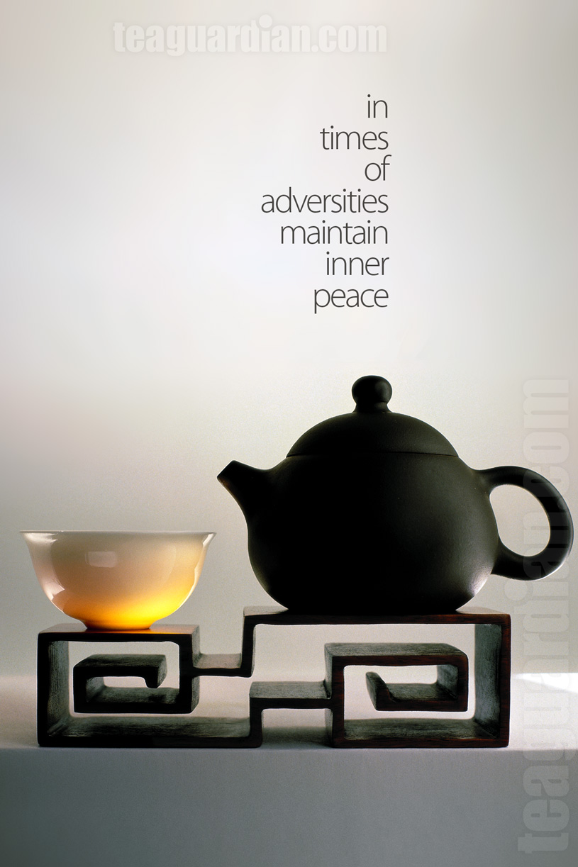 Cup with teapot on wooden rest in classic auspicious cloud design